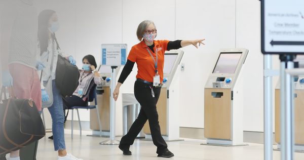 Passengers stay safe during check-in amid health protocols at DFW Airport